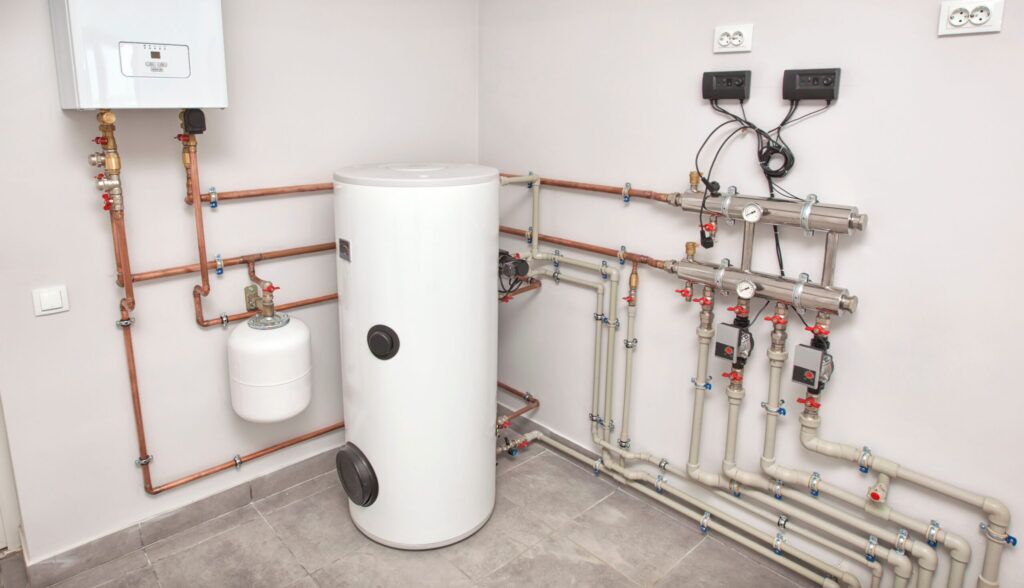 The boiler room with a lot of different equipment as a boiler, h Water Heater Installation in Fenton